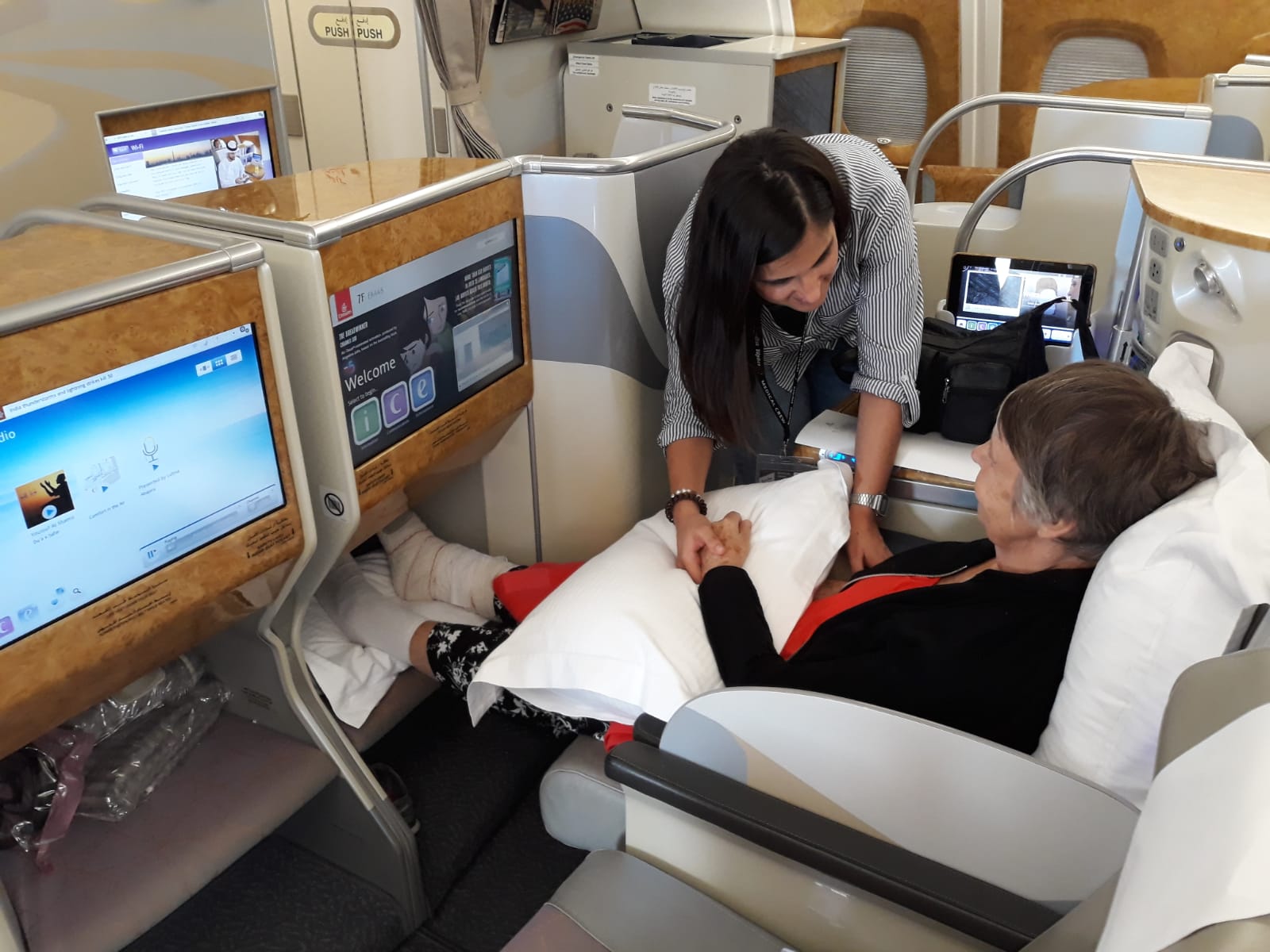 Ambulancia Aerea medical escort caring for a patient during a commercial flight repatriation